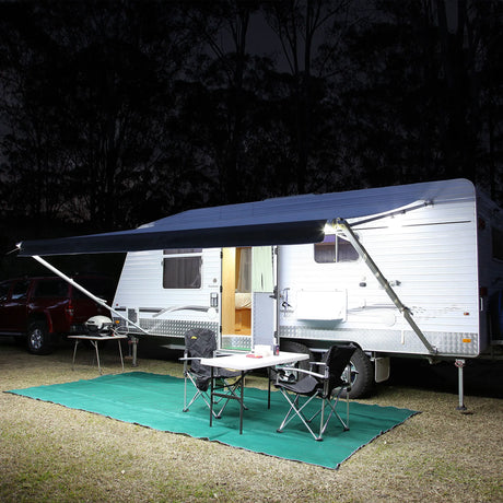 Hardkorr 5m white flexible LED tape light illuminating a caravan awning and camping table at night.
