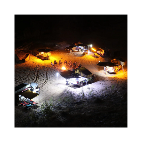 Hardkorr 6 bar LED camp light kit campsite view from above, with orange and white lights around vehicles.