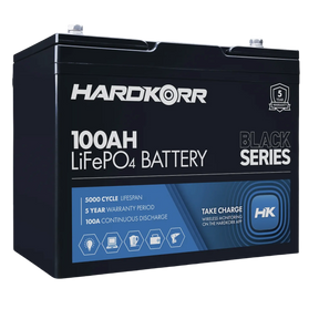 Hardkorr Black 100Ah 12V lithium battery front-left view with label and top terminals.