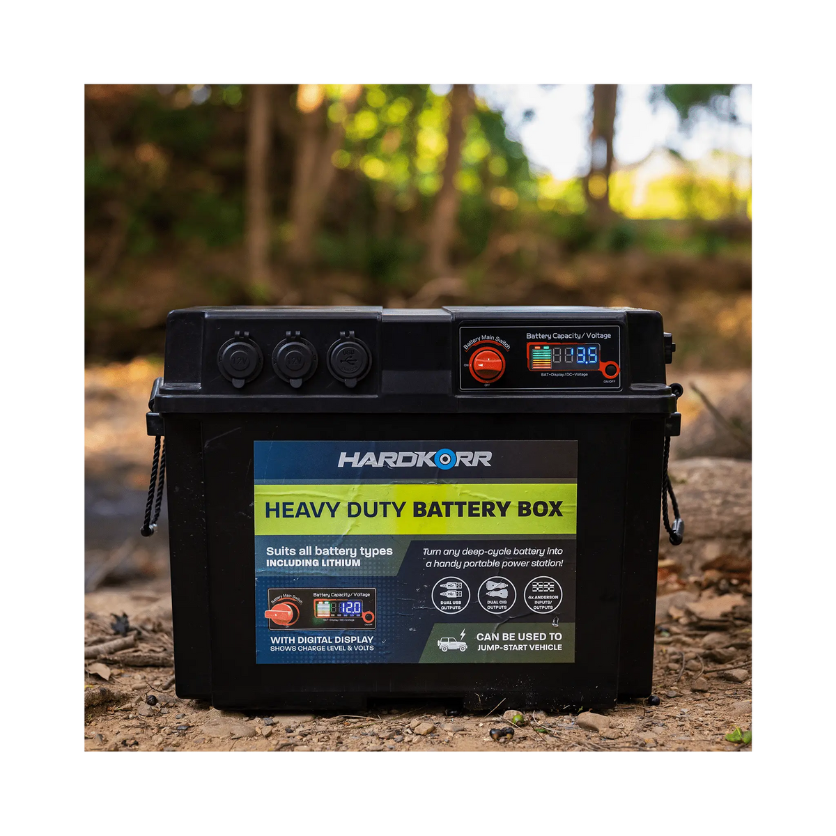 Black Hardkorr battery box front view on forest ground with its digital display illuminated.
