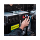 Black Hardkorr battery box control panel close up with a finger on the button beside the lit display.