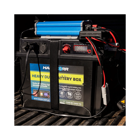 Black Hardkorr battery box strapped in a ute tray with positive and negative cables attached.