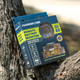 Hardkorr remote battery monitor retail packaging resting in a tree fork with its labelled front visible.