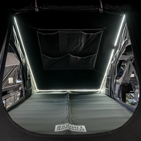 Outback Tourer 1.4 rooftop tent interior with side LED strips, mattress and wall pockets.
