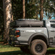 Outback Tourer 1.5 Pro Rooftop Tent closed on a tub rack on a grey ute.