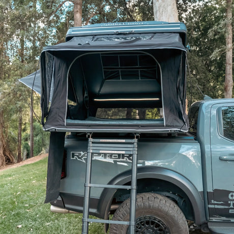 Outback Tourer 1.5 Pro Rooftop Tent open view with ladder pulled out on a grey ute.