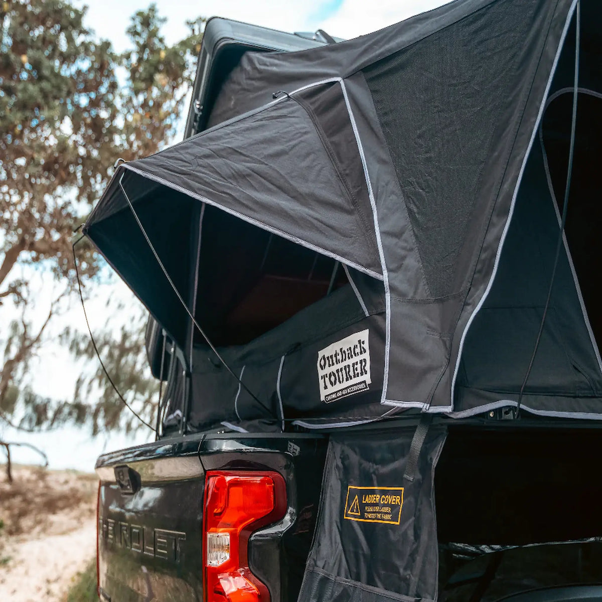 Outback Tourer 1.9 Pro Rooftop Tent rear rainfly view mounted on a black ute.