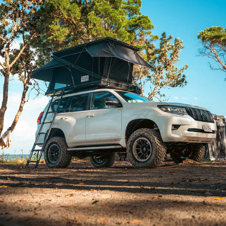 Outback Tourer 1250 Z Rooftop Tent front left open view above a white prado.