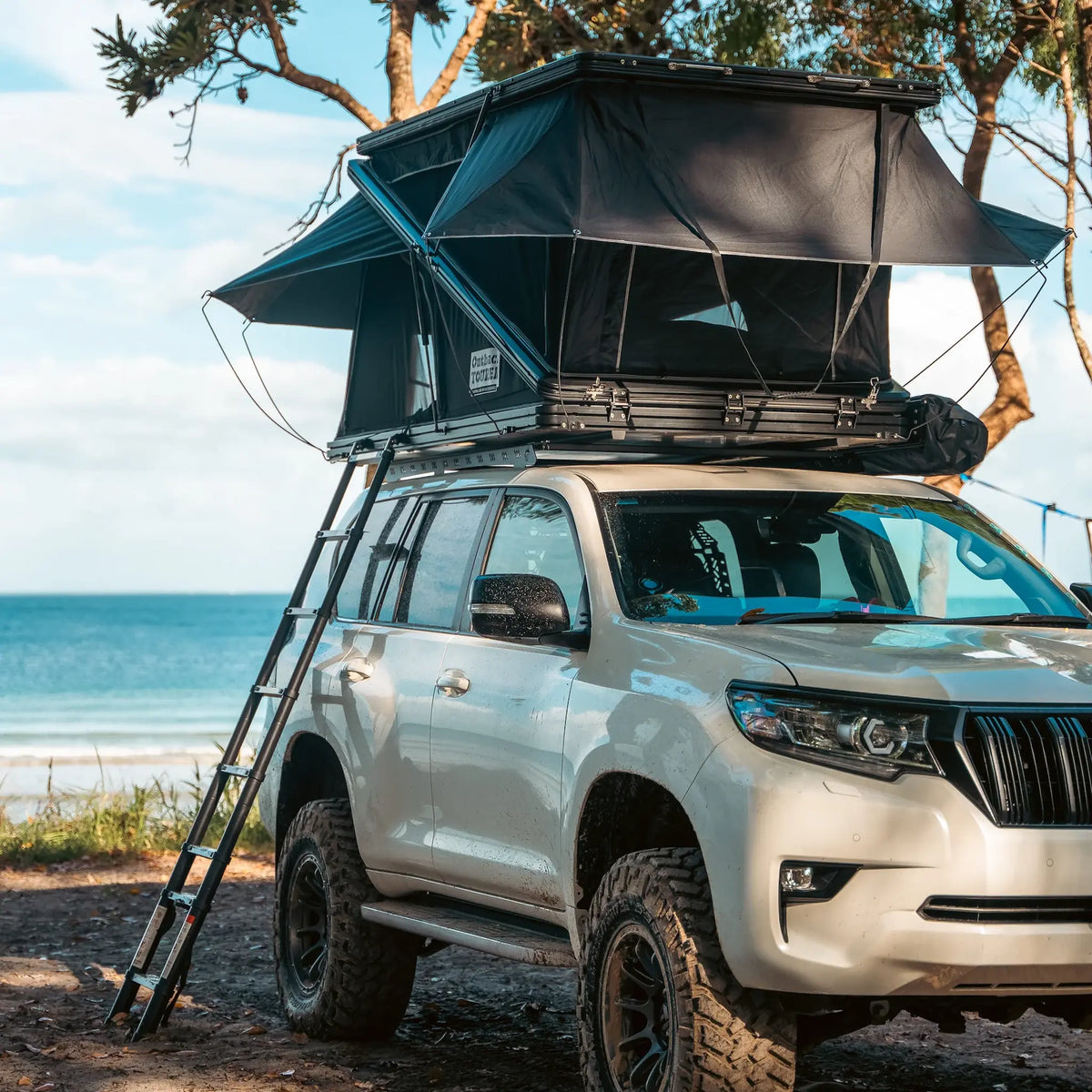 Outback Tourer 1250 Z Rooftop Tent front open view with ladder on a white Prado.