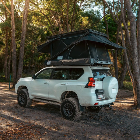 Outback Tourer 1250 Z Rooftop Tent rear left installed view on a white prado.