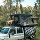 Outback Tourer 1550 Z Rooftop Tent open front right view with a person seated on a platform.