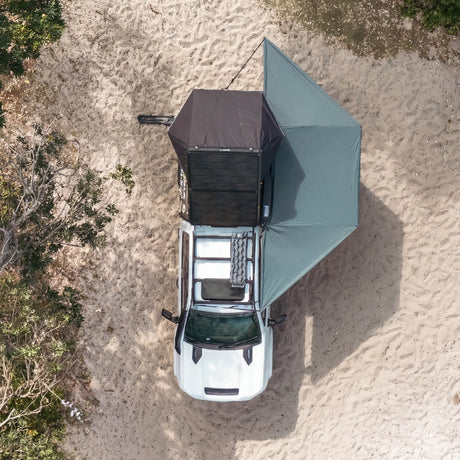 Outback Tourer 180 Awning birdseye view showing the side coverage beside a vehicle.