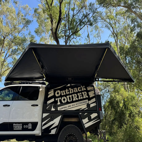 Outback Tourer 180 Awning side installed view with the awning arms and LED lights visible underneath.