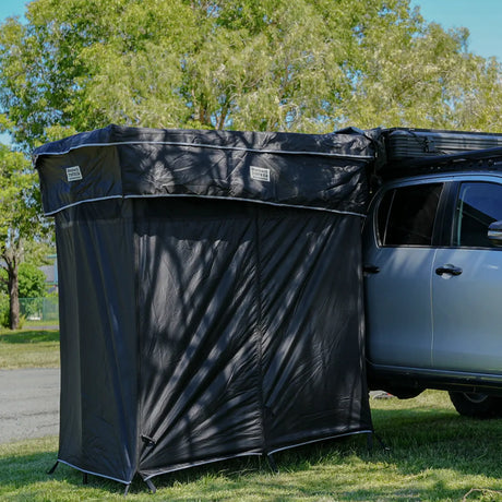 Outback Tourer Double Shower Awning mounted beside a 4WD with front and side walls visible.