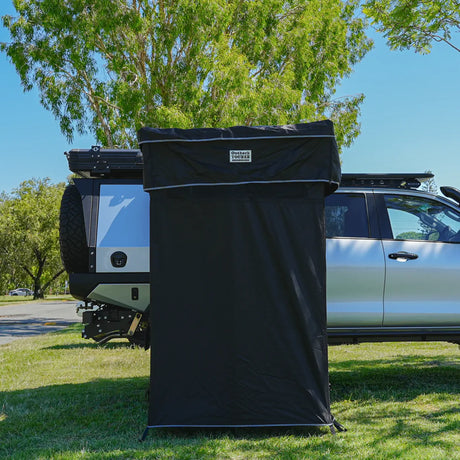 Outback Tourer Double Shower Awning side view mounted beside a vehicle.
