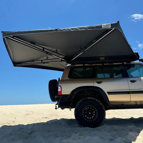 Outback Tourer Drivers Side 270 Awning underside view over a Nissan Patrol at the beach.