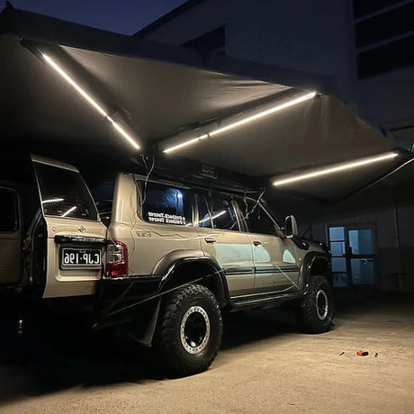 Outback Tourer Drivers Side 270 Plus Awning underside view with three led light strips at night.