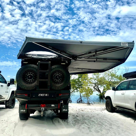 Outback Tourer Drivers Side 270 Plus with D Zipper Awning rear underside view on a beach.