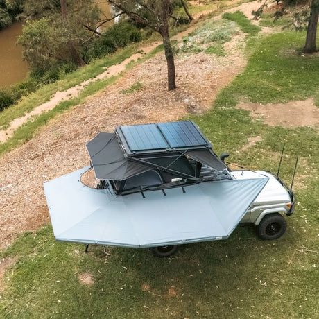 Outback Tourer Drivers Side 270 Plus with D Zipper Awning top right installed view beside a rooftop tent.