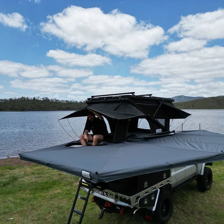 Outback Tourer Drivers Side 270 Plus with D Zipper Awning top view beside a ute and rooftop tent.