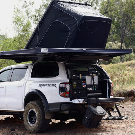 Outback Tourer Passenger Side 270 Awning back corner view with a rooftop tent and tailgate open on a Ford Ranger.