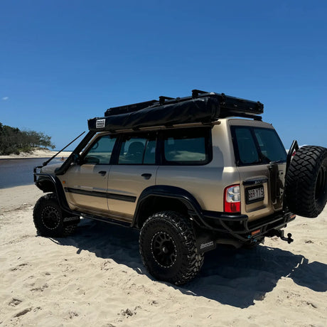 Outback Tourer Passenger Side 270 Awning packed down and mounted on a patrol roof rack at the beach.
