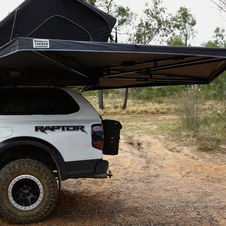 Outback Tourer Passenger Side 270 Awning open view on a white ford ranger beside a dirt track.