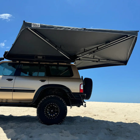 Outback Tourer Passenger Side 270 Awning underside installed on a Patrol parked on a beach.