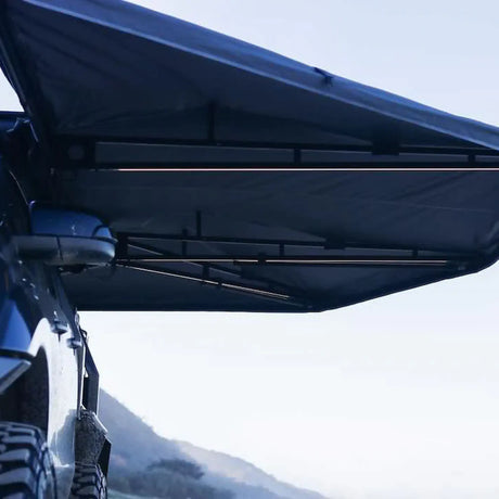 Outback Tourer Passenger Side 270 Plus Awning underside canvas and support arm detail beside a 4WD.