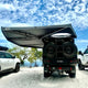 Outback Tourer Passenger Side 270 Plus with D Zipper Awning rear underside view on a beach.