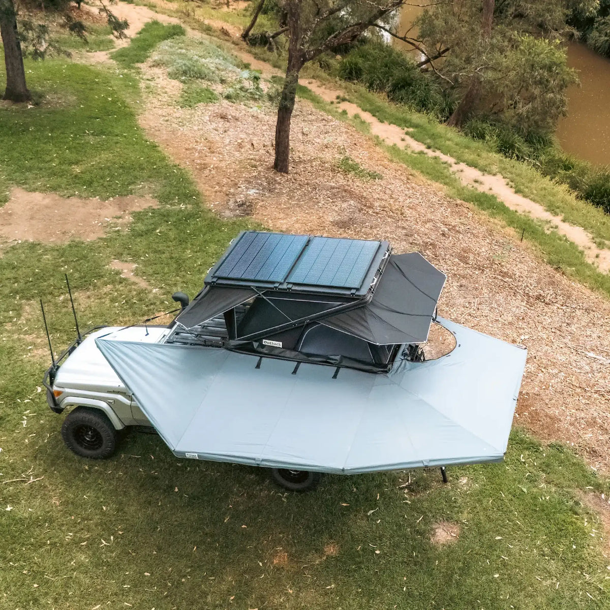 Outback Tourer Passenger Side 270 Plus with D Zipper Awning left top view with rooftop tent and solar panels.