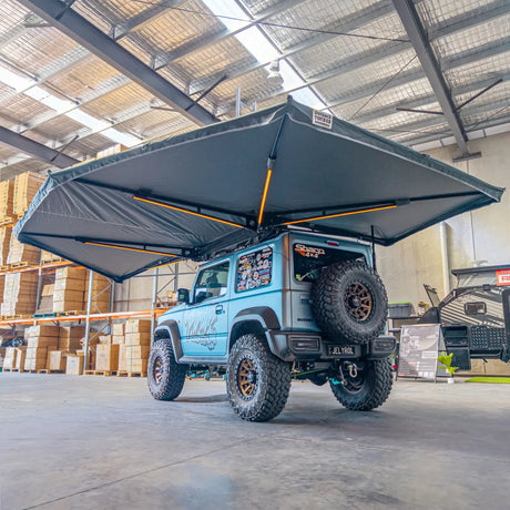 Outback Tourer Passenger Side 270 Plus X-Tend Awning rear-corner underside view on a blue Jimny.