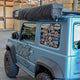 Outback Tourer Passenger Side 270 Plus X-Tend Awning closed in a black travel bag on a Jimny.