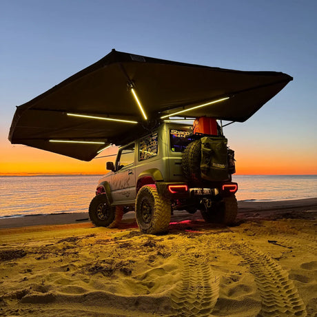 Outback Tourer Passenger Side 270 Plus X-Tend Awning with LED lights on the beach.