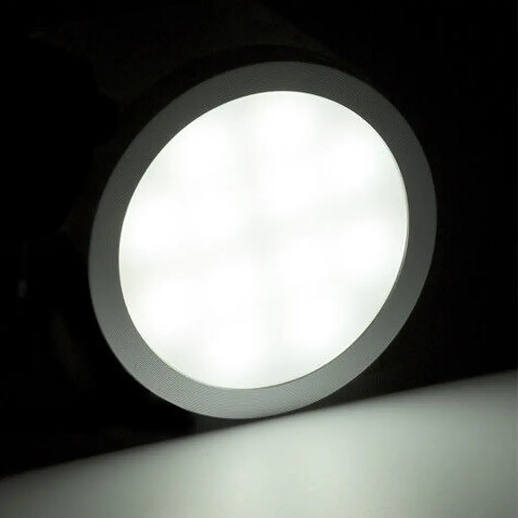 Rekcharge 12V silver cool white LED downlight with its round diffuser fully lit inside the silver rim.