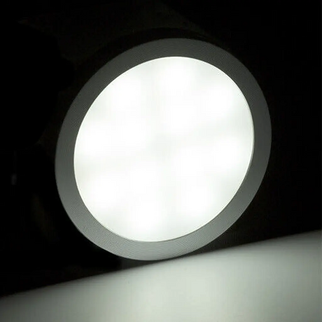 Rekcharge 12V silver cool white LED downlight with its round diffuser fully lit inside the silver rim.