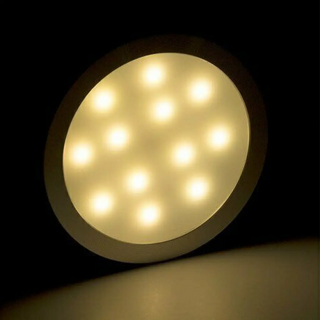Rekcharge 12V silver warm white LED downlight illuminated with distinct LED points behind the diffuser.