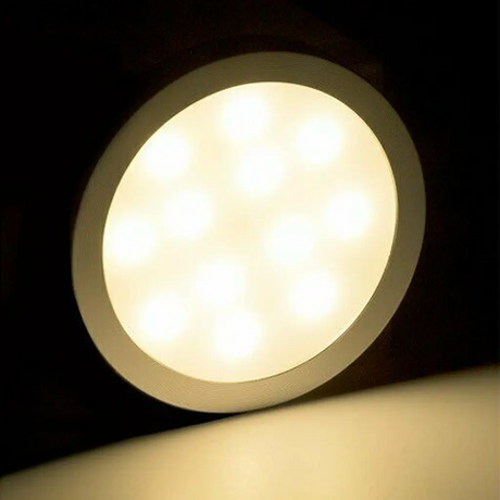 Rekcharge 12V silver warm white LED downlight with bright LED points glowing through the round diffuser.