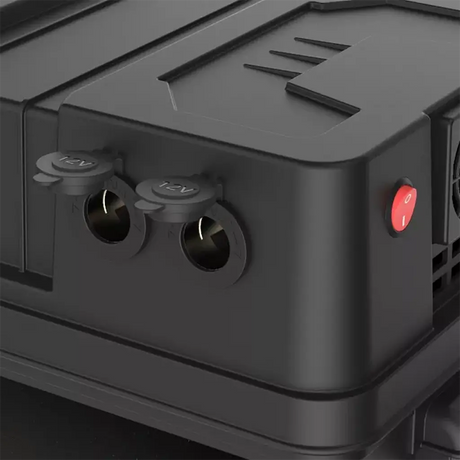 Rekcharge 12V portable battery box side close up with two round sockets and their protective caps open.