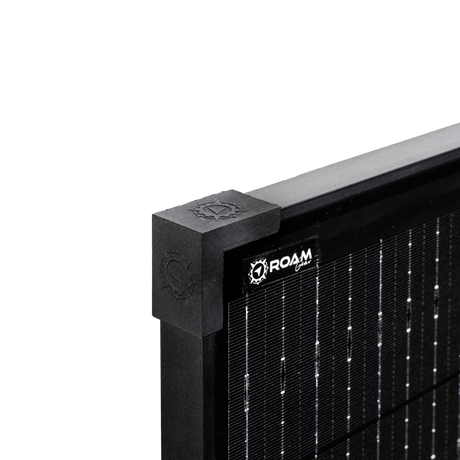 Roam Gear 160W 12V slimline black glass solar panel corner close up showing the corner cap and logo beside the cells.
