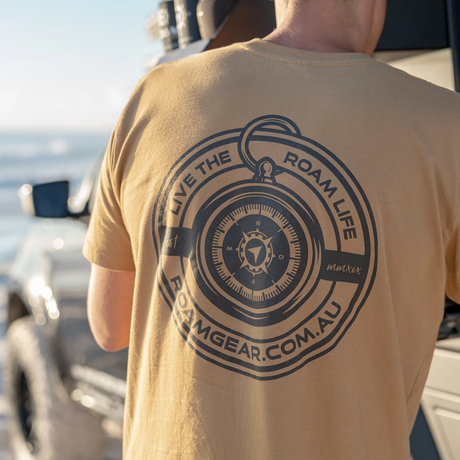 Man wearing the Roam Gear "Live the Roam Life" male tan T-shirt from the rear with the back graphic visible.