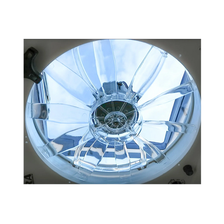 TRA 12V electric roof vent hatch fan close up viewed from below with daylight through the clear blades.